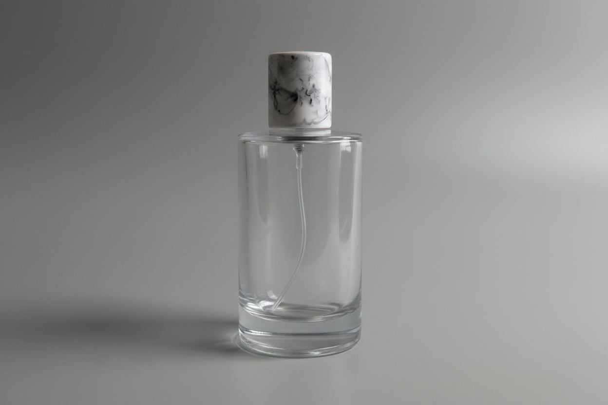 Glass perfume bottle complete with pump, spray and cap.